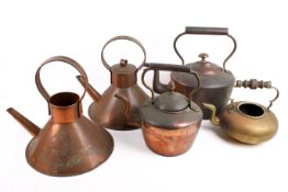 A group of assorted vintage copper kettles.