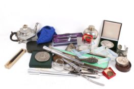 A collection of assorted white metal items, some silver.