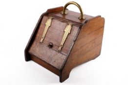A Victorian purdonium oak coal scuttle with brass fittings. With zinc liner.