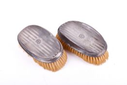 A pair of early 20th century silver mounted clothes brushes.