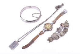 A small group of silver and white metal jewellery items.