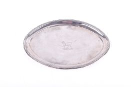 A silverplated oval card tray. With bead rim and central engraved leopard crest, with wooden back.
