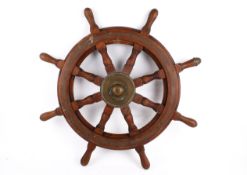 A ships wheel stamped Simpson Lawence. Brass bound with turned wooded handles.