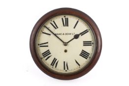 A vintage stained wood round 'Wake & Dean Ld' wall clock.