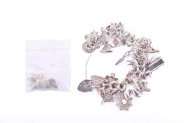 A silver charm bracelet with numerous charms.