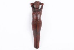 A novelty carved wooden nut cracker in the form of a reclining woman.
