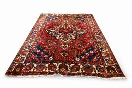 A large red ground rug, purchased new from John Lewis.