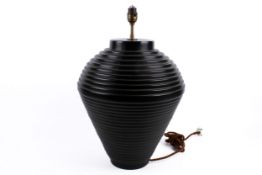 A contemporary black ceramic table lamp of ribbed baluster form.