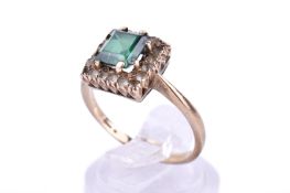A yellow metal and green stone ring.