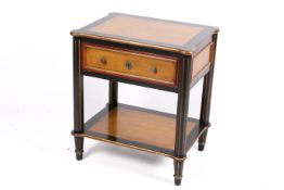 A contemporary Japaned bedside table. Having a drawer over a lower tier, raised on fluted supports.