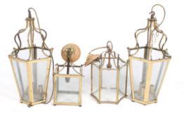 A group of four assorted brass and glass hall lanterns. Including a pair.