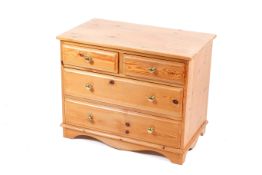 A contemporary pine chest of drawers. Two short over two long.