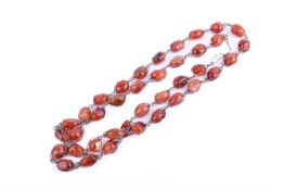A long agate stone necklace.