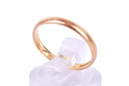 A 22ct gold wedding band. Hallmarked, width 2mm, misshapen size circa M, weight 1.8g.