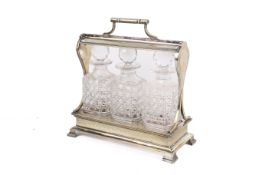 A silver plated tantalus. Having three moulded glass decanters, each with a spherical stoppers.
