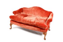 A vintage camel back two seater sofa with burnt orange upholstery.
