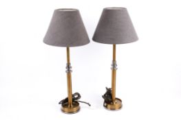 A pair of contemporary Pooky Metro table lamps. Raised on circular bases.