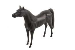 A cast metal scuplture of a standing horse. Unsigned.