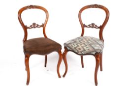 Two walnut balloon back side chairs. Having carved detail to the frame, raised on cabriole supports.