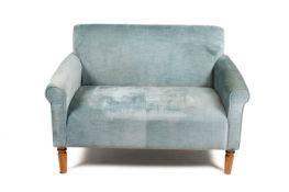 A contemporary two seater sofa with turqouise upholstery. Raised on turned tapering supports.