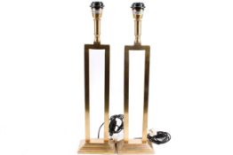 A pair of contemporary Parex gilt metal table lamps. Raised on rectangular stepped bases.