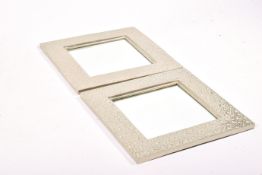 A pair of contemporary square cast metal framed wall mirrors.