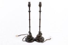 A pair of Pooky Chukka contemporary table lamps. Raised on a circular base.