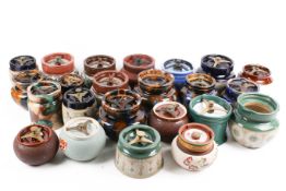 A large collection of assorted ceramic tabacco jars. Including Carlton Ware, etc.