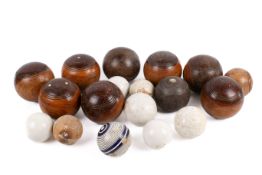 A group of assorted Lignum Vitae bowls and ceramic Jacks marked F.H Ayres.