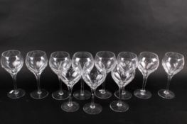 Eleven large cut glass crystal wine glasses.