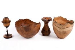 A group of five carved treen items. Including bowls, egg cup, some signed to base.