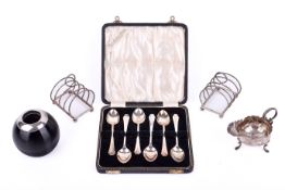 A small group of silver table items.