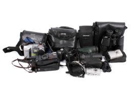 A collection of assorted cameras, monoculars and binoculars.