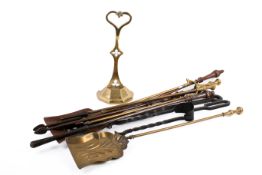 A group of assorted fire irons and a brass door stop.
