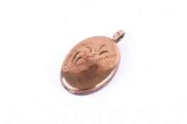 A small 9ct gold oval locket. Hallmarked to the back, 1.6cm x 1.1cm, gross weight 1.