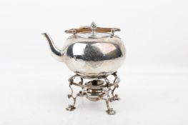 An 18th century silver kettle on a stand.