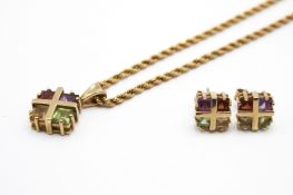 A matching stone set pendant and earrings.