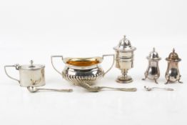 A small group of silver table items.