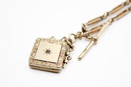 An unmarked yellow metal Albert chain and locket.