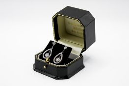 A pair of 18ct white gold and diamond drop earrings. Set with round brilliant cut diamonds of 0.
