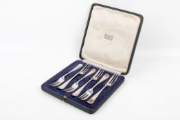 An early 20th century boxed set of six silver cake forks.