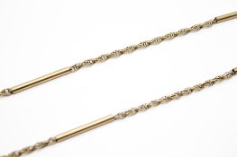A yellow metal twist and bar link necklace.