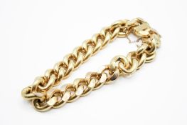 A yellow metal filled curb chain bracelet.