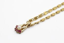 A gold plated chain with a small yellow metal pendant.