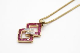 A yellow metal, diamond and ruby pendant.