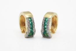 A pair of yellow metal and green and white stone earrings.