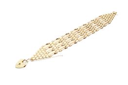 A 9ct gold gate link bracelet. Partial hallmarks, with hallmarked heart shaped locket, W2.3cm x L17.