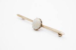 A yellow metal and precious opal bar brooch.