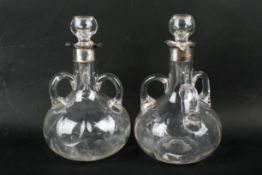 A pair early 20th century silver mounted carafes.