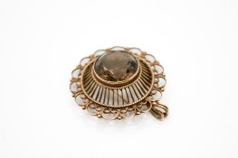 A 19th century 9ct gold and smoky quartz brooch. The faceted round cut stone circa 1.